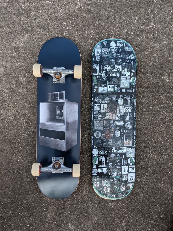 two skateboards laying on the ground next to each other, one with an oven