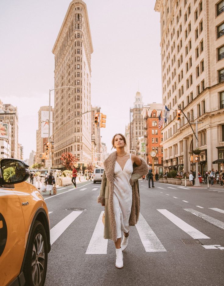 a woman is walking across the street