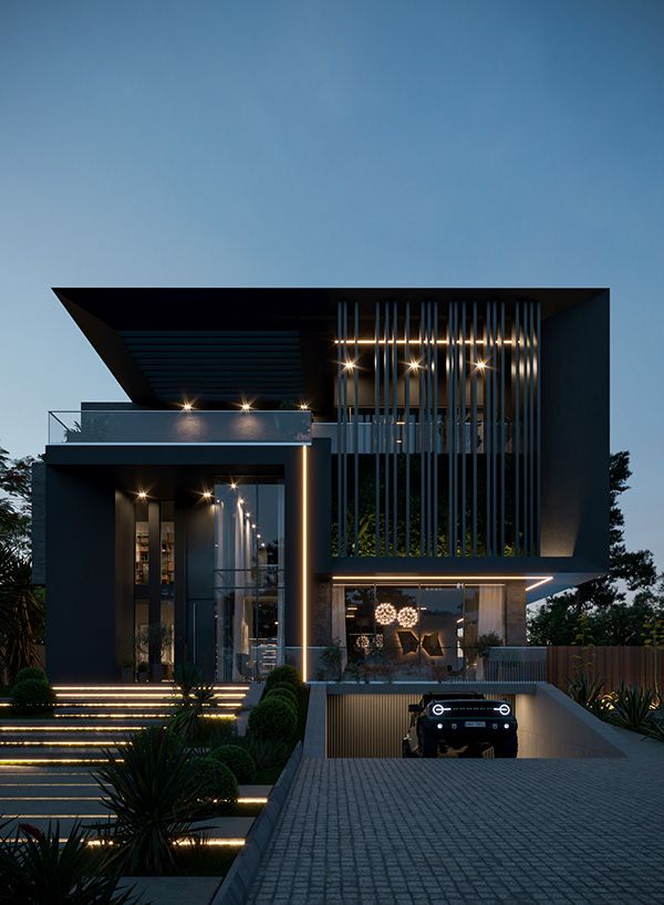 a car is parked in front of a modern house at night with its lights on