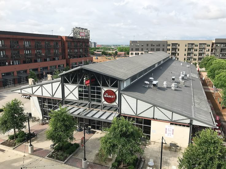 an overhead view of a train station with trees and buildings in the backgroud