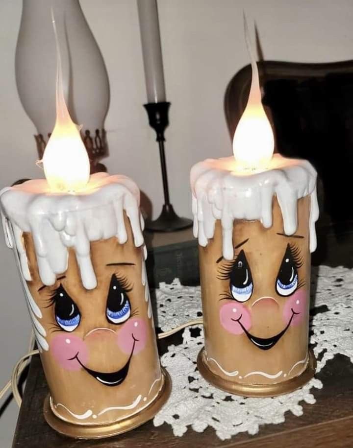 two candles with frosting on them sitting on a table