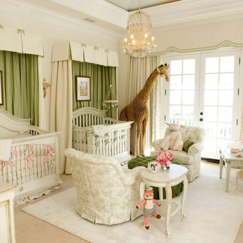 a baby's room with a giraffe statue on the wall and furniture