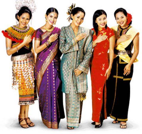 several women in colorful dresses posing for the camera