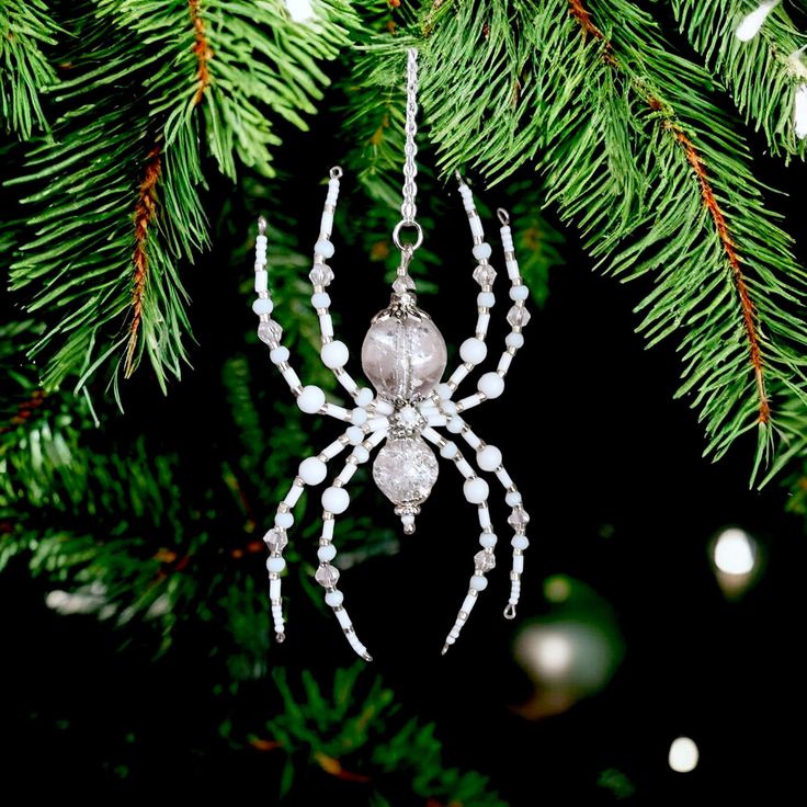 a spider ornament hanging from a christmas tree