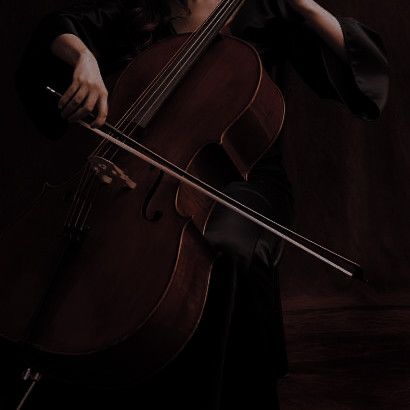 a woman holding a cello in her right hand