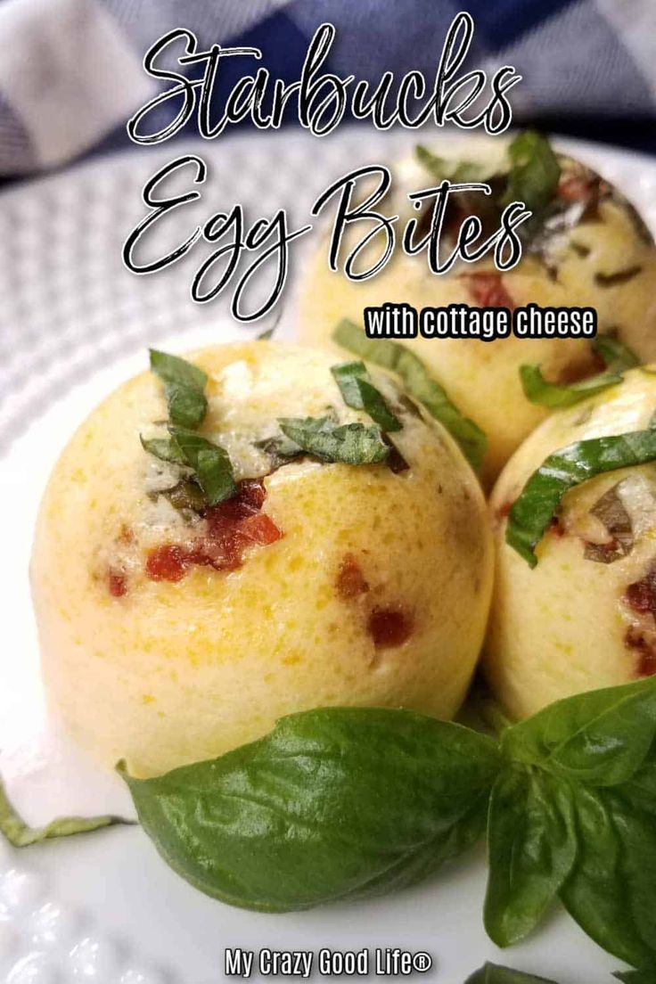 some food is on a white plate and has green leafy leaves around it with the words starbucks's egg bites