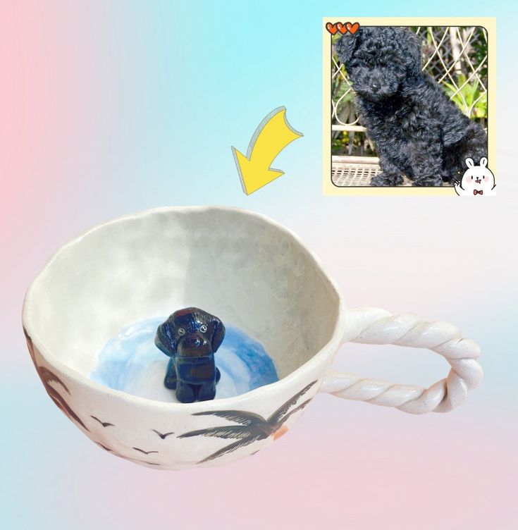 a black dog sitting in a white bowl with rope around it's neck and water inside