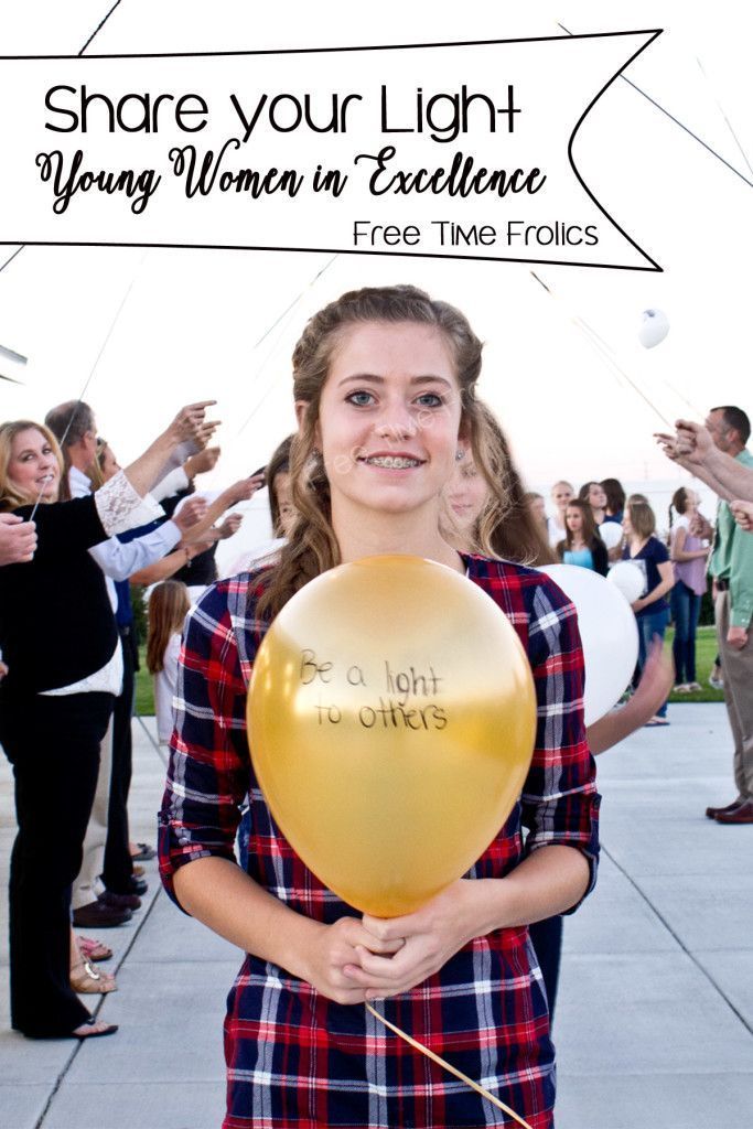 a woman holding a balloon that says share your light