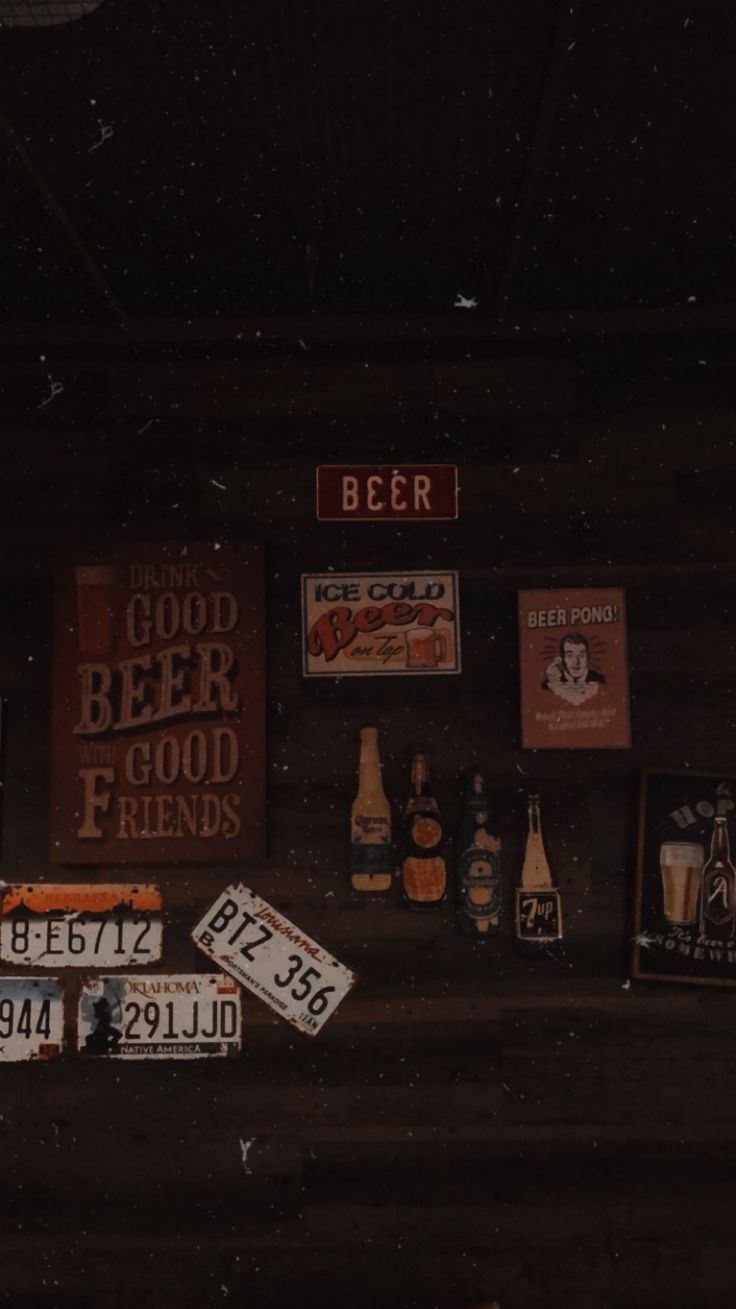 there are many signs on the wall with beer