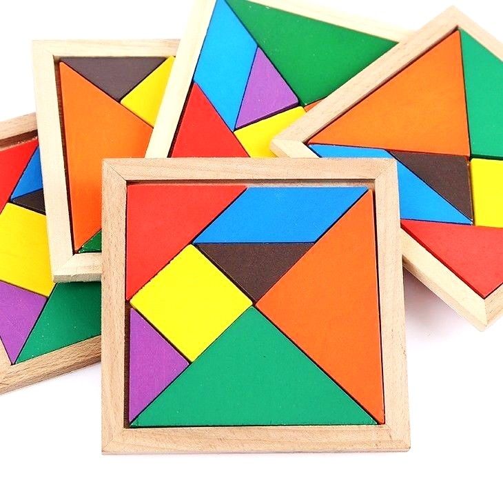 four colorful wooden puzzles sitting on top of each other