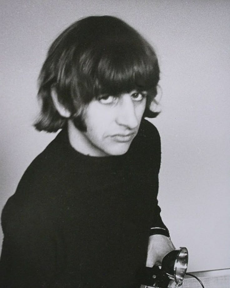 black and white photograph of a man holding a telephone