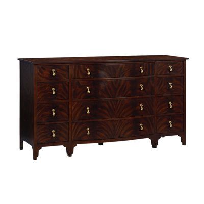 an old dresser with many drawers and knobs on the front, in dark wood