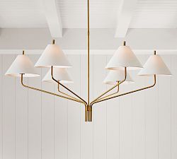 a chandelier hanging from the ceiling in a room with white walls and wood paneling