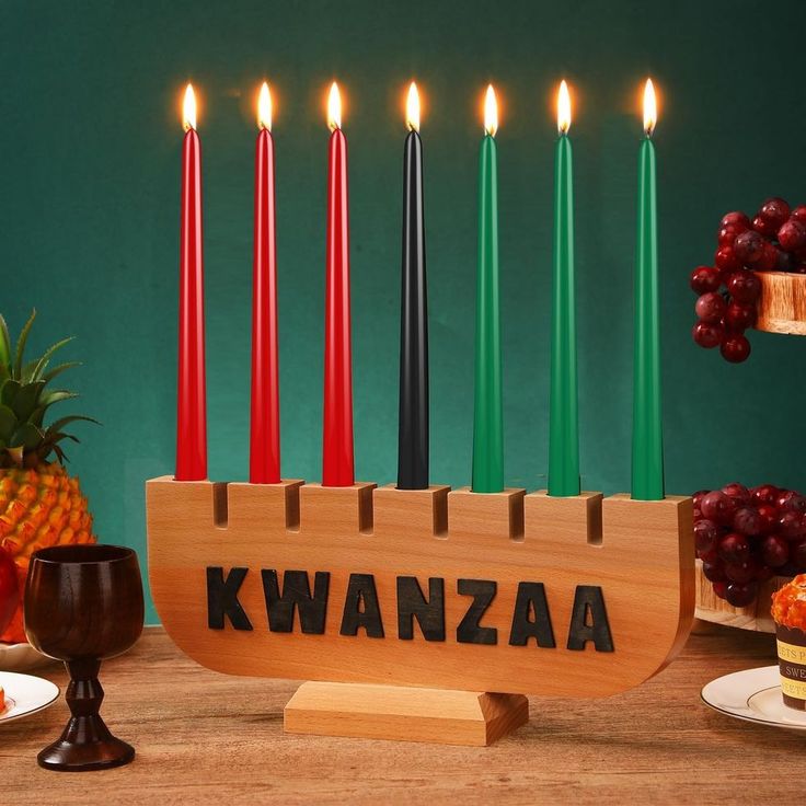 a hanukkah menorah with lit candles and fruit on the table