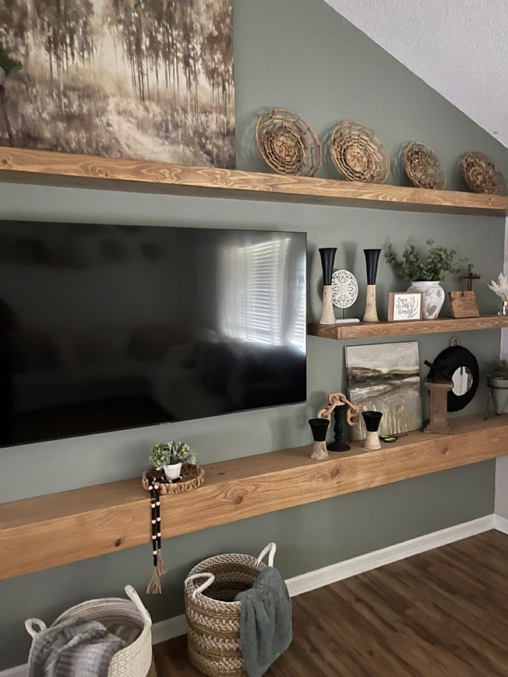 a flat screen tv sitting on top of a wooden shelf