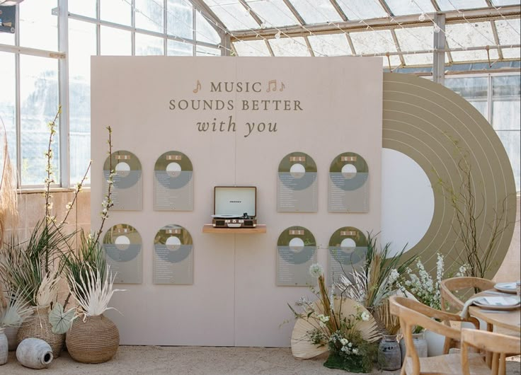 there is a display in the middle of a room with many plants and vases