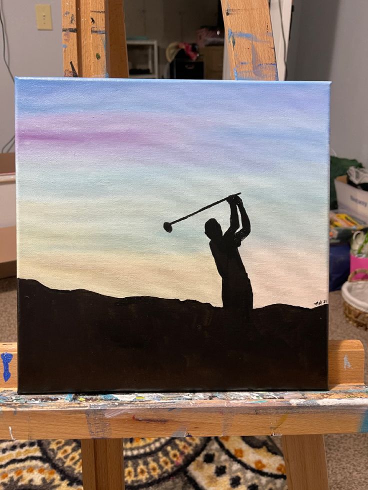 a painting of a man holding a golf club on top of a wooden easel