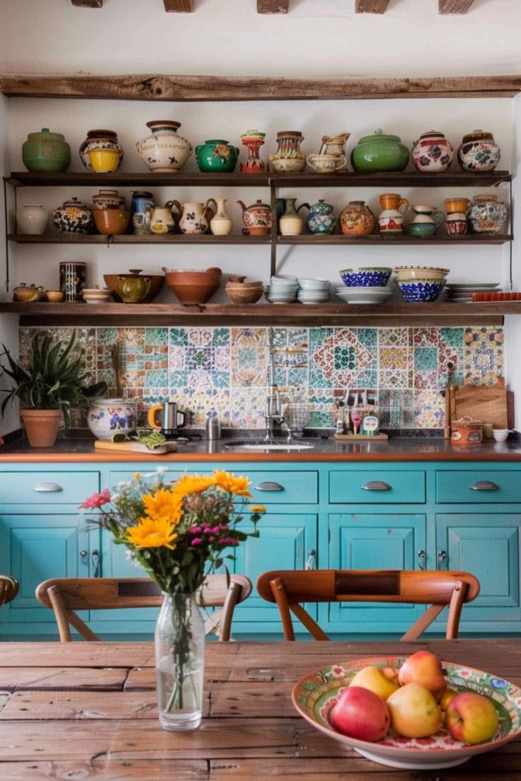 a kitchen with blue cabinets and wooden table