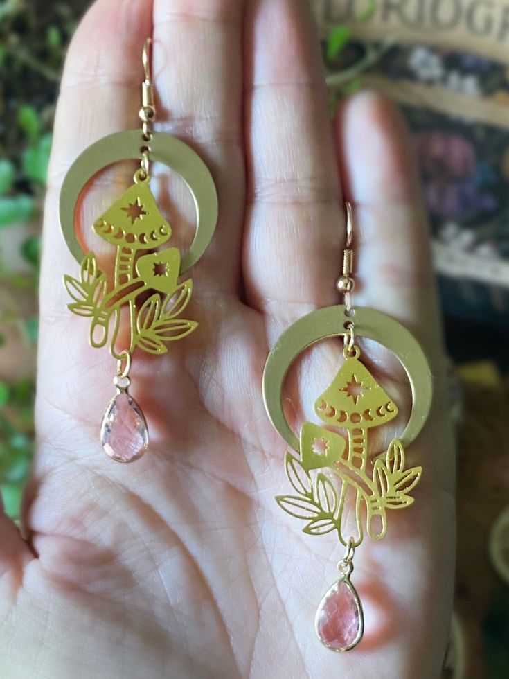 Beautiful handmade earrings with golden mushrooms, crescent moon charms and delicate baby pink glass crystals on golden ear wires🌙 Length: 8 cm  More beautiful jewelry can be found in my shop:  https://www.etsy.com/dk-en/shop/ONCEUPONAPOTIONDK?ref=seller-platform-mcnav&section_id=21367729 Should you have any questions please feel welcome to send me a message✨ Wiccan Earrings, Witchy Earrings, Celestial Boho, Celestial Magic, Mushroom Earrings, Handmade Gifts For Her, Moon Charm, Pink Glass, Love And Light