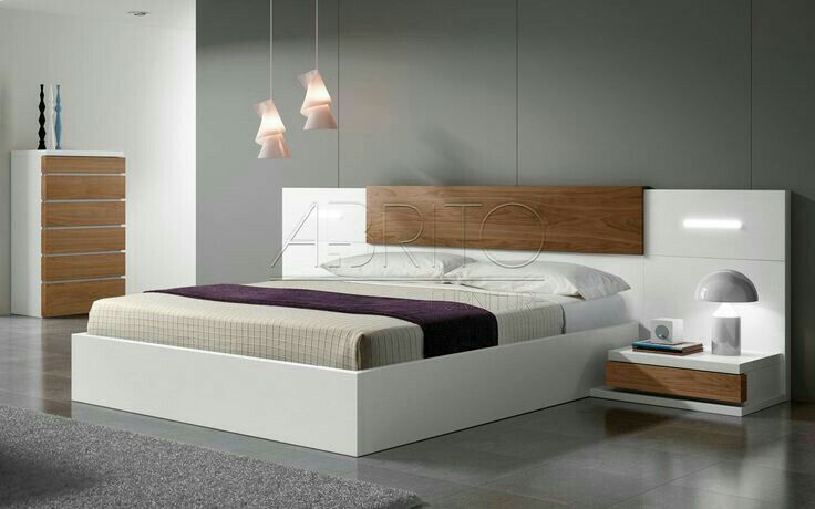 a modern bedroom with white and wood furniture