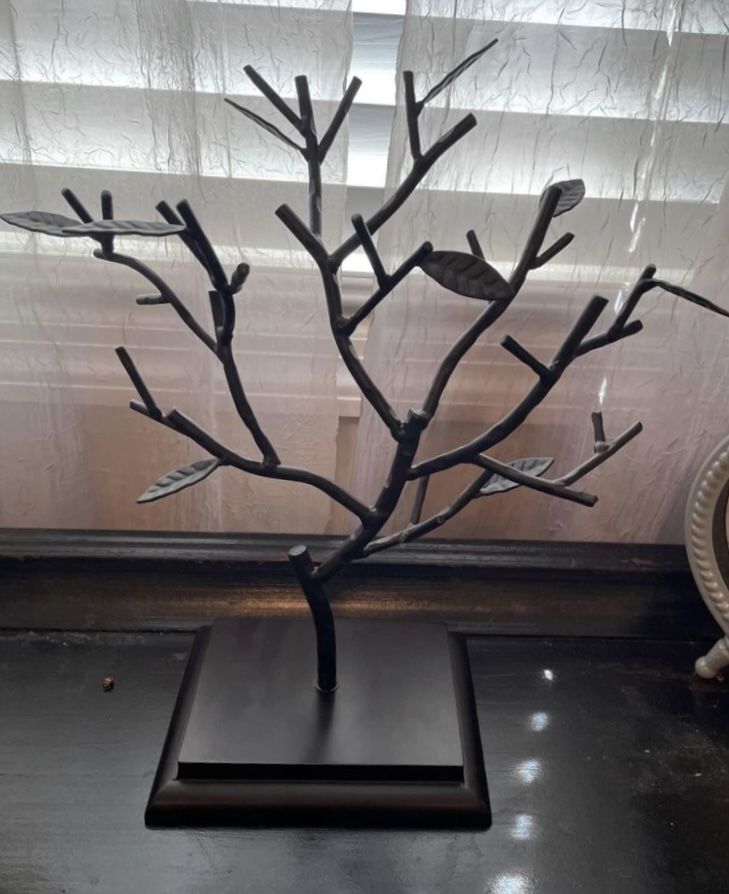 a metal tree sculpture sitting on top of a table