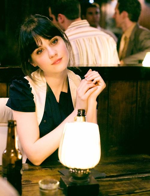 a woman sitting at a table in a restaurant