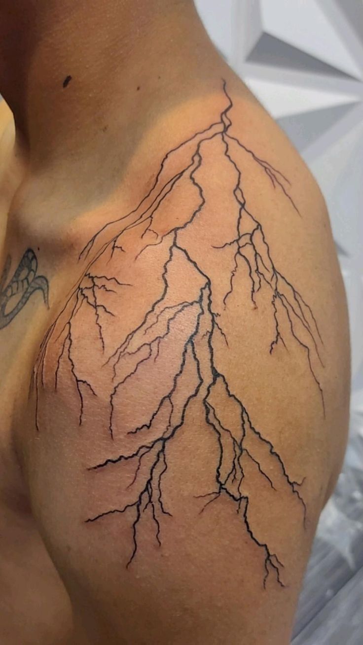 a man's arm with lightning tattoo on it