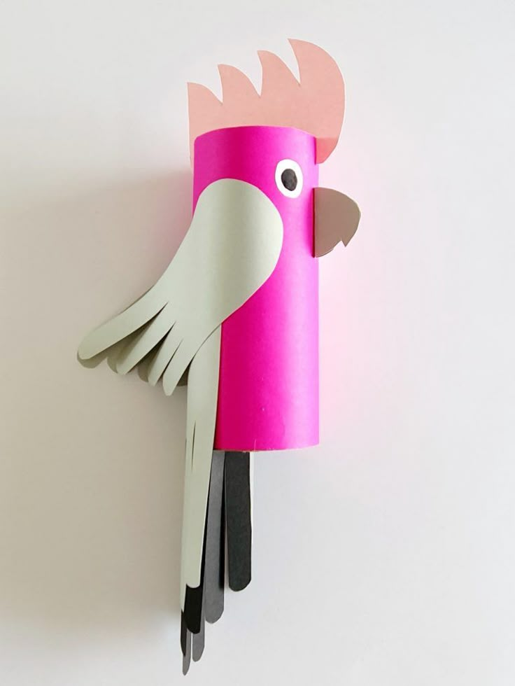 a pink bird made out of construction paper