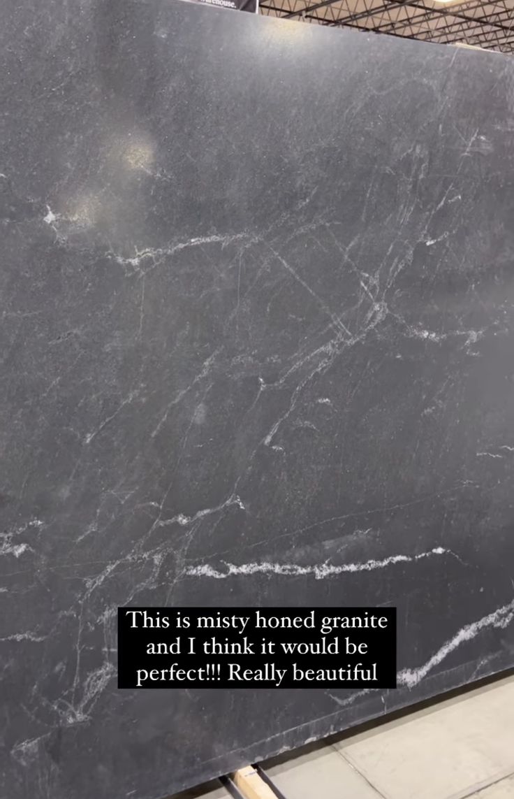 a large black marble slab with a quote on it that says, this is misty honed granite and i think it would be perfect really beautiful