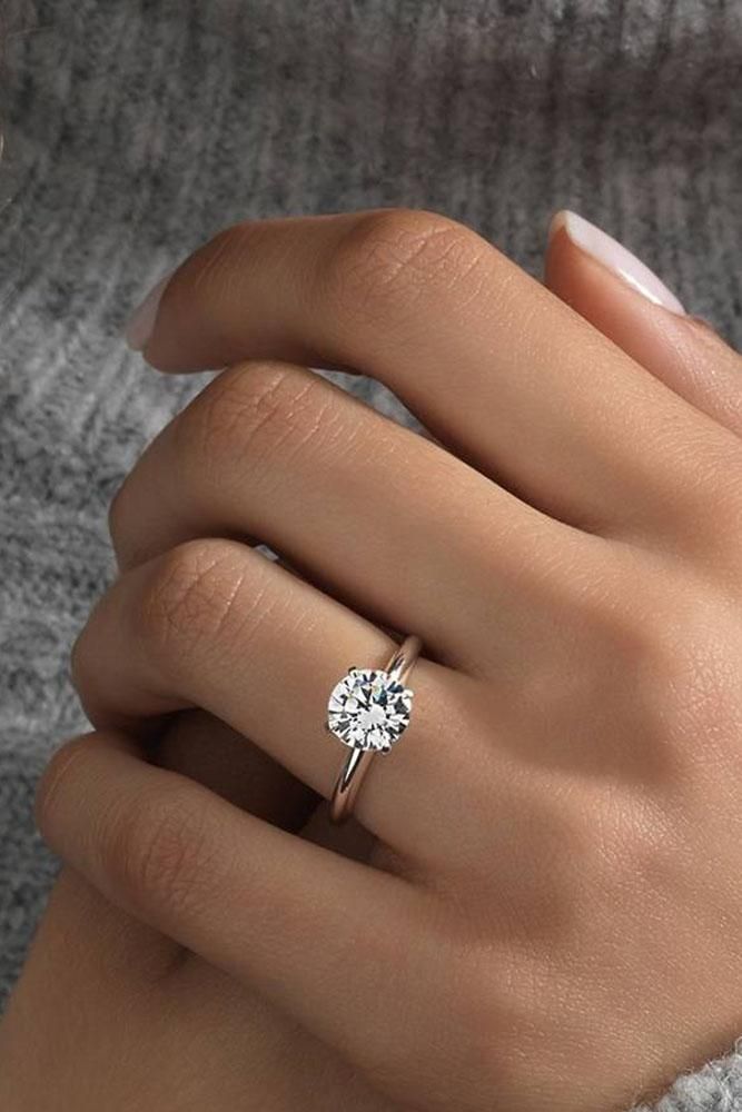 a woman's hand with a diamond ring on it