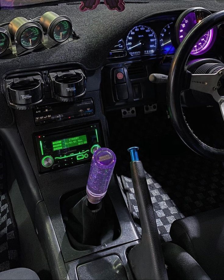 the interior of a car with various gauges and dash lights, including steering wheel