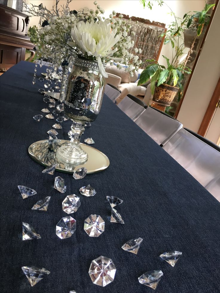 a table topped with lots of diamonds on top of a blue table cloth