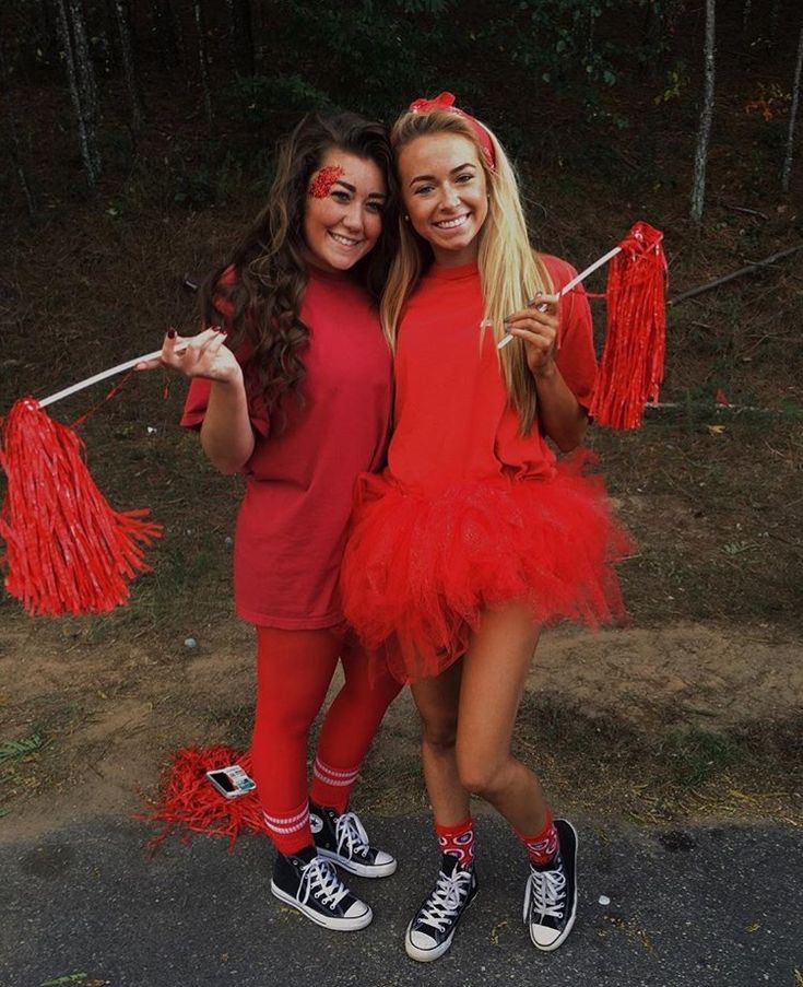 two girls dressed in red posing for the camera