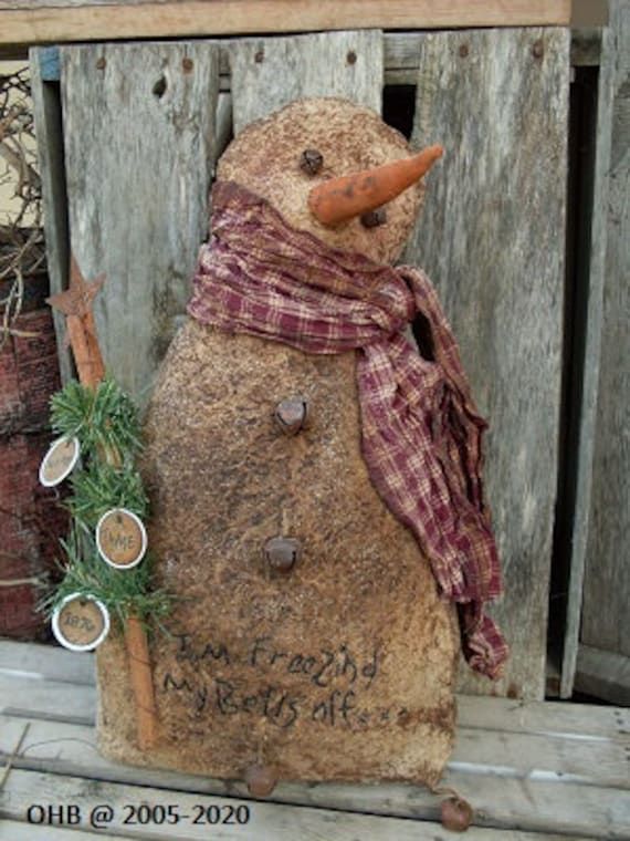 a stone snowman with a scarf and hat