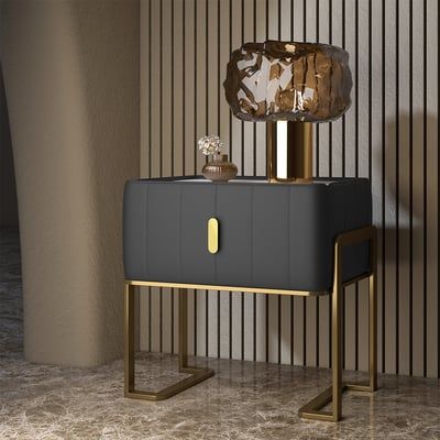 a white and gold cabinet with a crystal top on it's stand in front of a striped wall