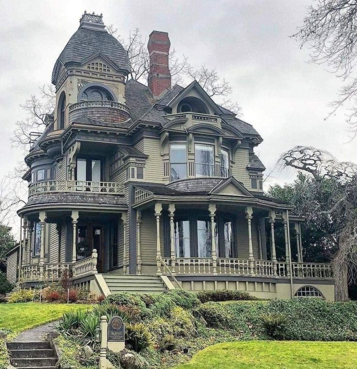 an old victorian style house on a cloudy day