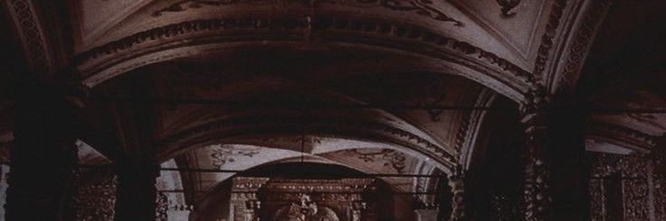 the interior of an old church with statues and arches