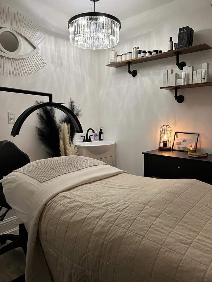 a bedroom with a bed, desk and shelves on the wall next to each other