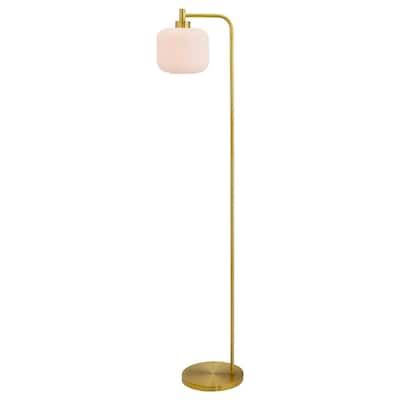 a brass floor lamp with a white glass shade