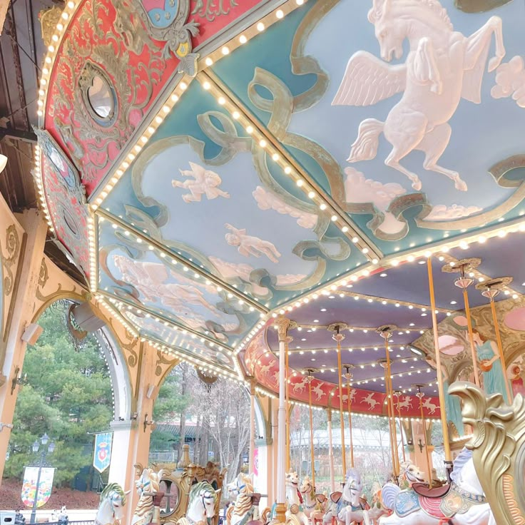 an ornately decorated merry go round with lights and carousels in the foreground