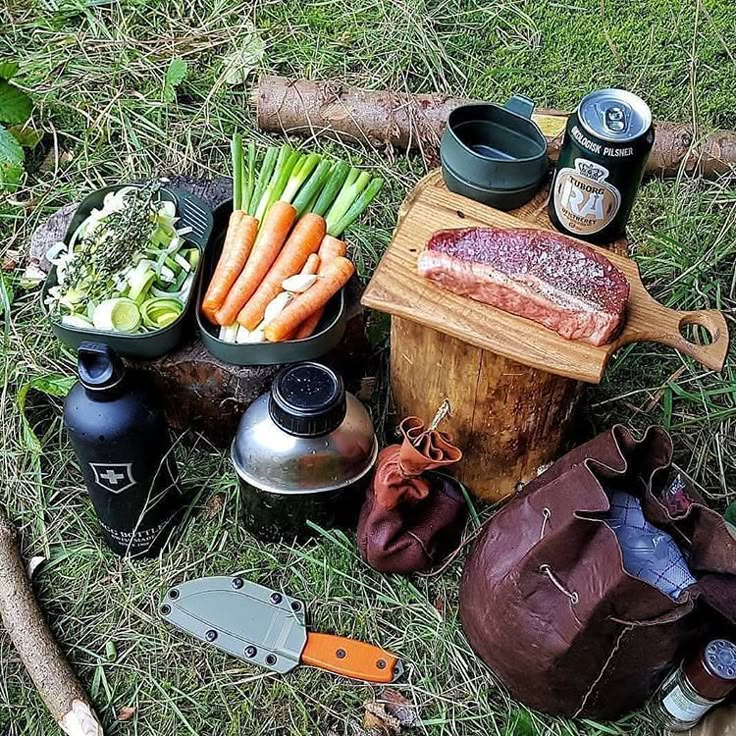 an assortment of food is laid out on the ground with utensils and other items