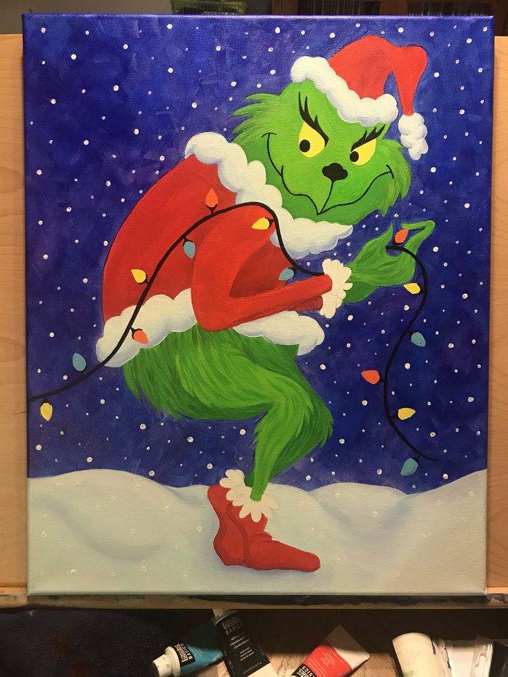 the grinch painting is being displayed in front of some paint tubes and other items