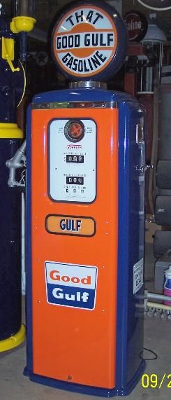 an orange and blue gas pump sitting in a garage