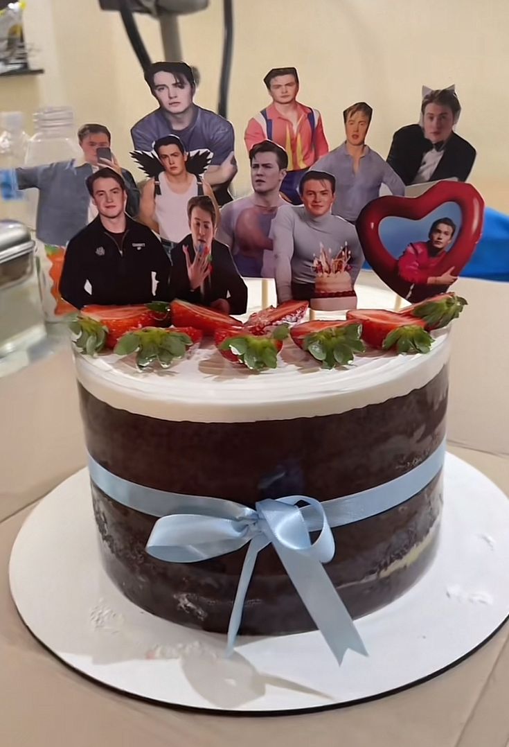 a birthday cake with pictures of people on it