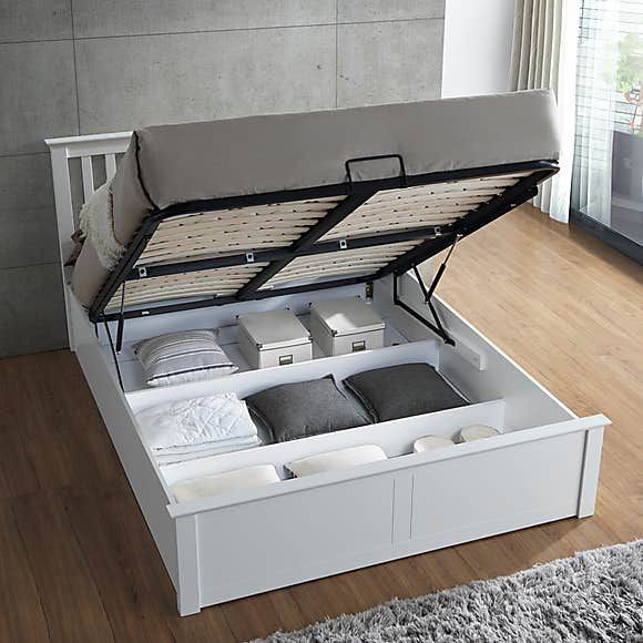 a bed with two pull out drawers underneath it