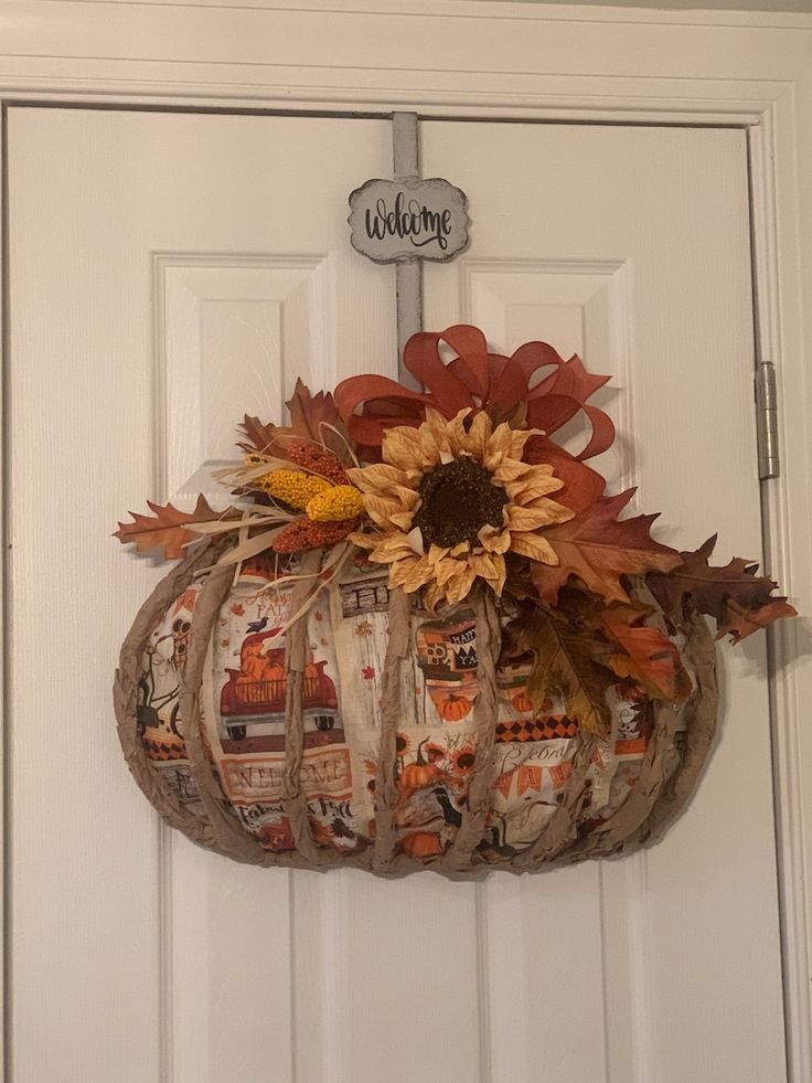 a white door with a pumpkin and sunflower on it