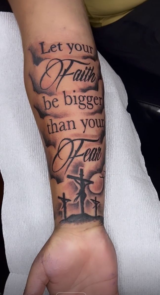 a person with a tattoo on their arm that says let your faith be bigger than your fear