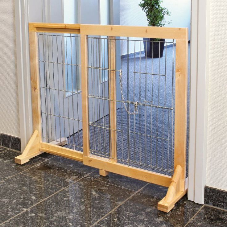 a wooden gate is open on the floor