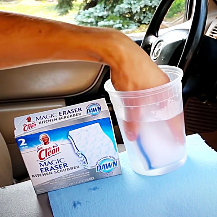 a person's foot sticking out of a cup in the back seat of a car