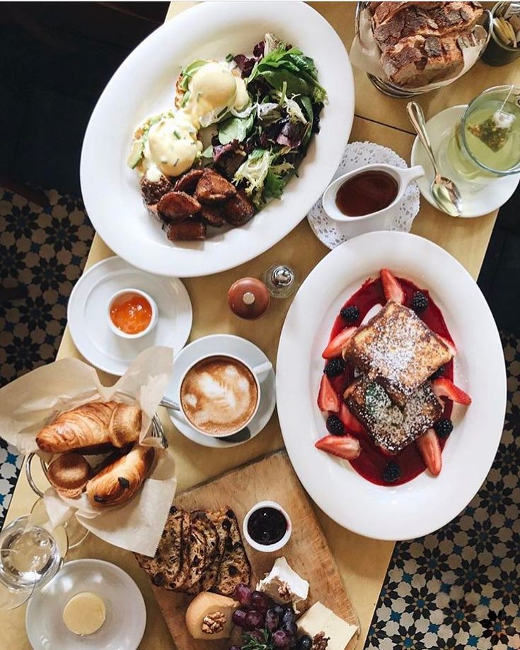 a table topped with plates of food and drinks